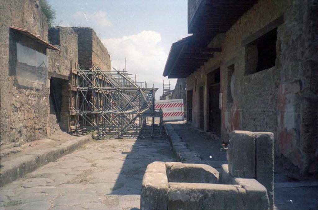 III.2.3 Pompeii. July 2011. Looking east on Via dell’Abbondanza, showing scaffolding outside entrance. Photo courtesy of Rick Bauer.