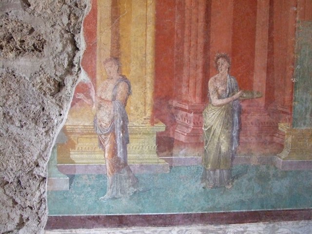 III.4.b. Pompeii.  March 2009. Room 3.  Oecus.  West wall.  Detail of wall painting of figure.