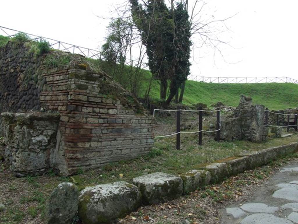 III.10.6 Pompeii. March 2009. Looking south west on Via Nola. Street altar on north east corner of insula and east wall of thermopolium. 