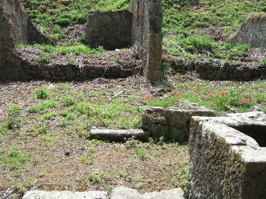 III.11.1 Pompeii. May 2006. Remains of threshold into front room, with III.11.a (side entrance).  On the right of the picture is the fountain on Via Nola, and to the rear of it, the small vicolo leading south.
