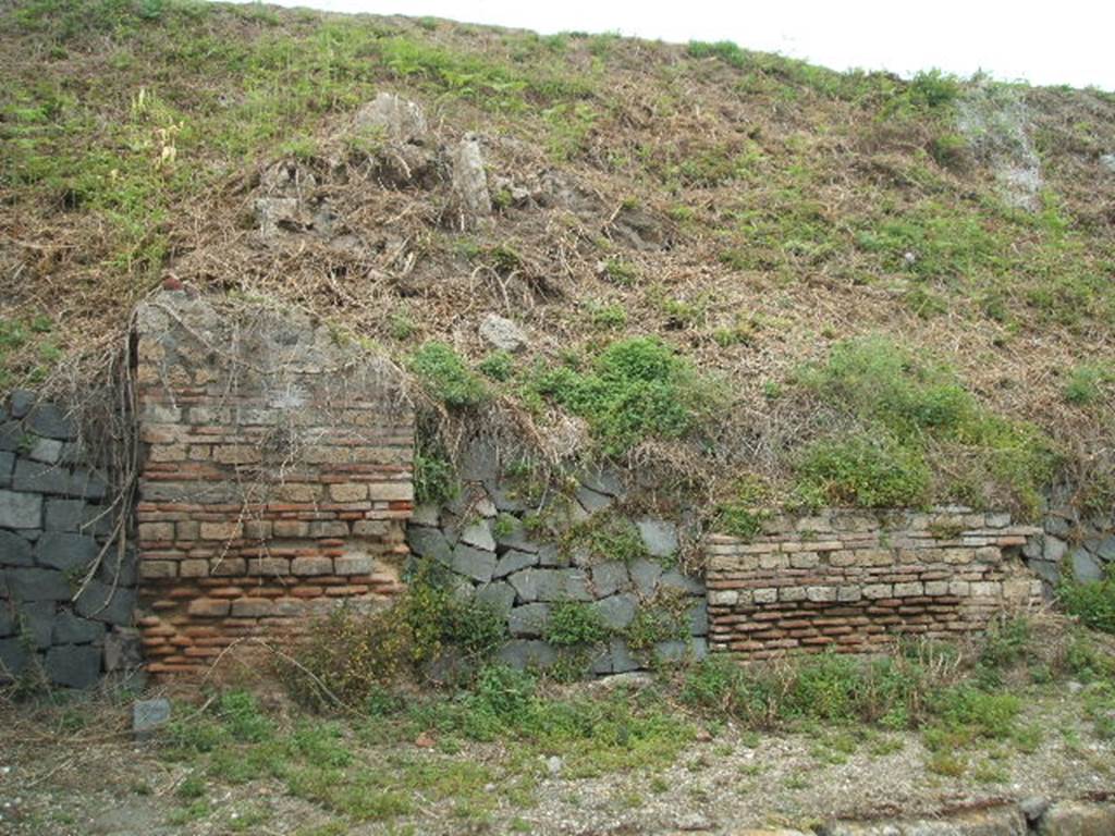 IV.1.f Pompeii. May 2005. Entrance, filled in with grey stones.

The doorways that used to front onto the northern side of Via Nola, forming Regio IV, have now been filled in as a wall to keep the earth bank back from the road.  It is very difficult to find the exact position of these doorways and link them to any site plan.