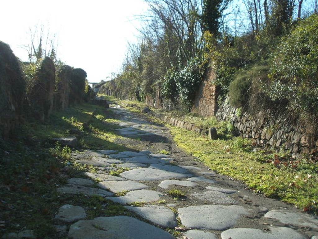 III.12, Pompeii. December 2004.  Via di Nola from the Nola Gate looking west.      IV.5 