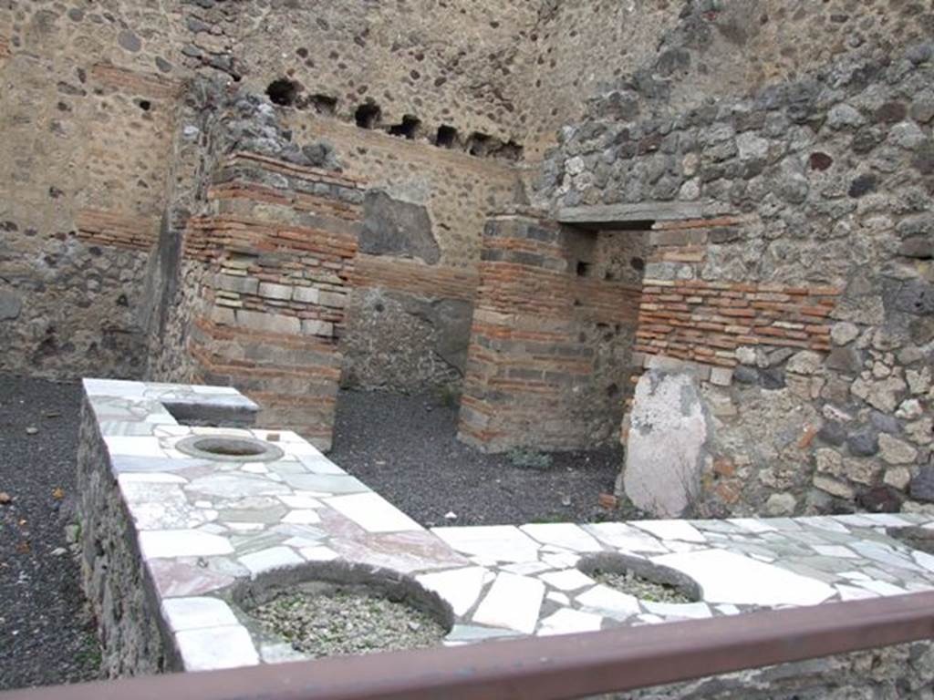 V.1.1 Pompeii.  December 2007.  Marble counter with four urns and hearth.