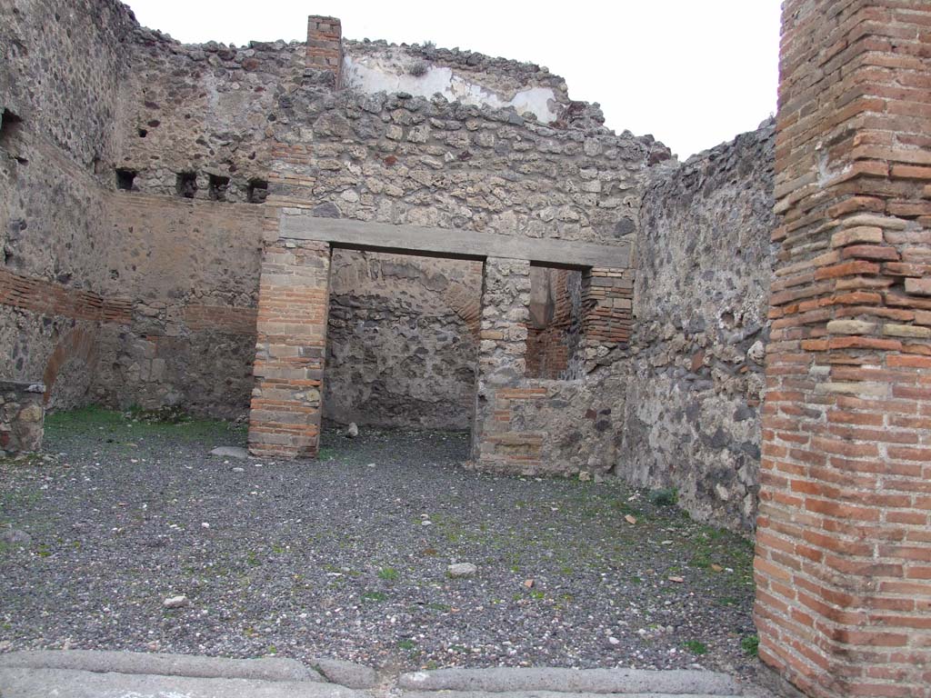 V.1.2 Pompeii. December 2007. North wall with kitchen and latrine on the left and room with window on the right.