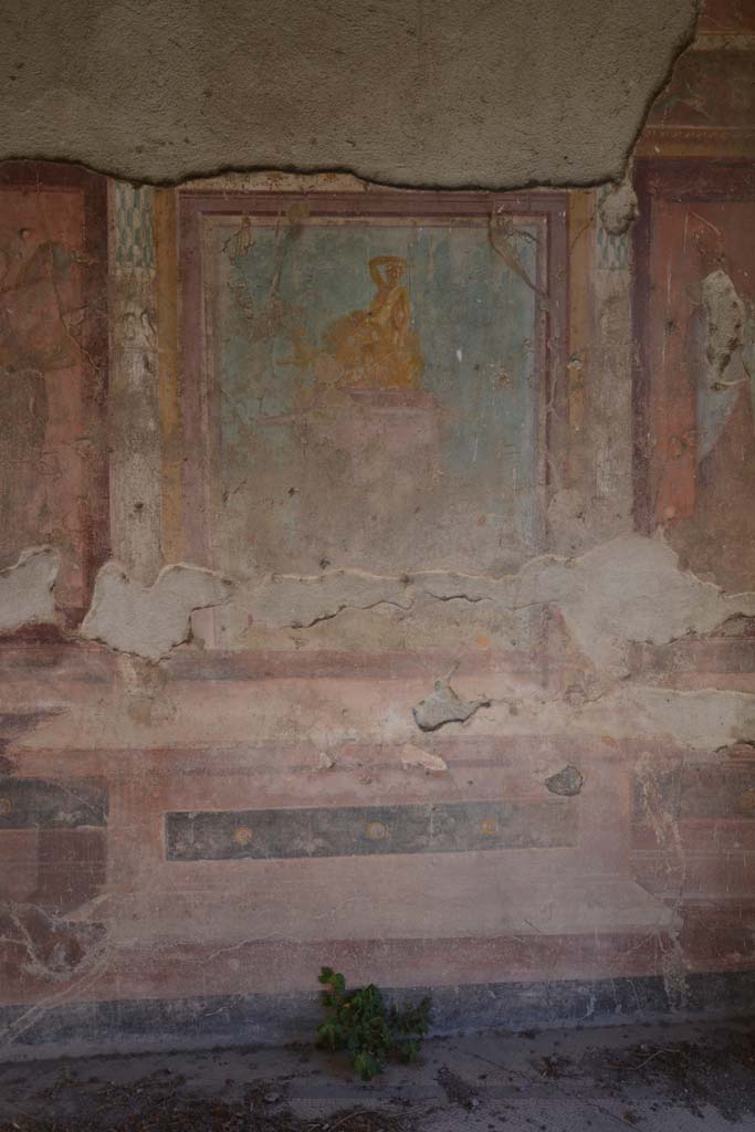 V.1.18 Pompeii. May 2012. Painting of golden seated figure in centre of east wall of exedra “y”, described as both Dionysus, or perhaps Arianna. Photo courtesy of Buzz Ferebee. 

