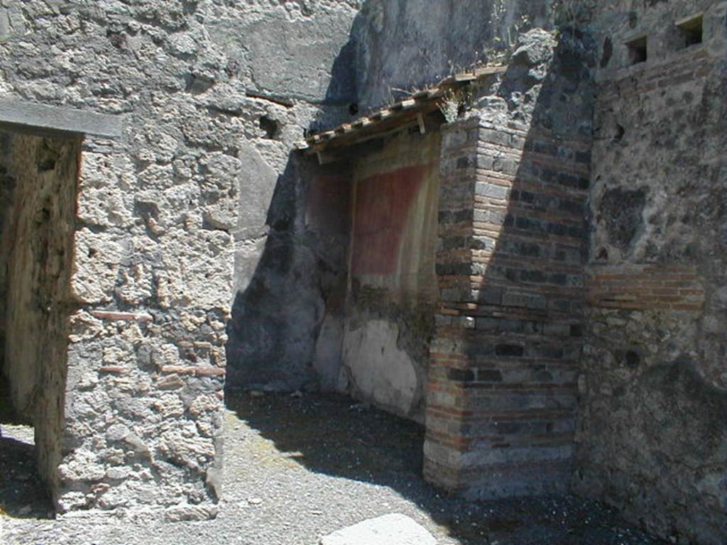 V.1.31 Pompeii. May 2005.  North side of shop, passage with vaulted latrine at rear left, and remains of base of stairs, in foreground.
