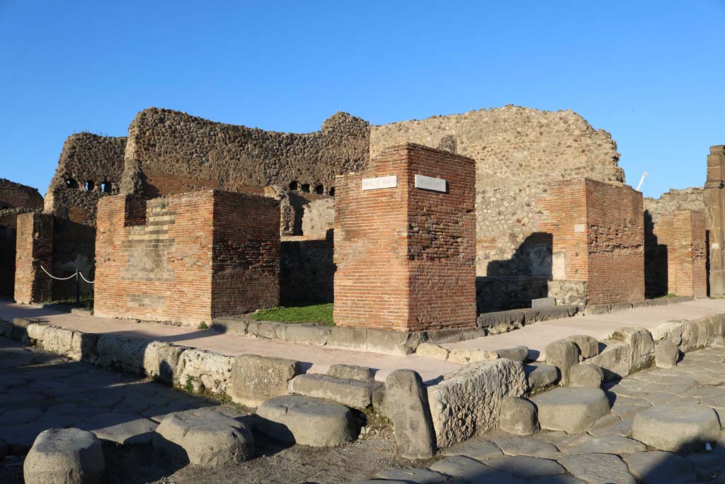 V.1.32 Pompeii, left of centre. December 2018. Looking north-east to entrance doorway on Via del Vesuvio. 
The linked doorway at V.1.1 can be seen on the right of centre, at the junction with Via di Nola. Photo courtesy of Aude Durand.


