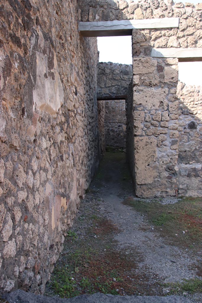V.2.13 Pompeii. October 2022. 
Corridor to rear kitchen on west side of north wall of bar-room. Photo courtesy of Klaus Heese.

