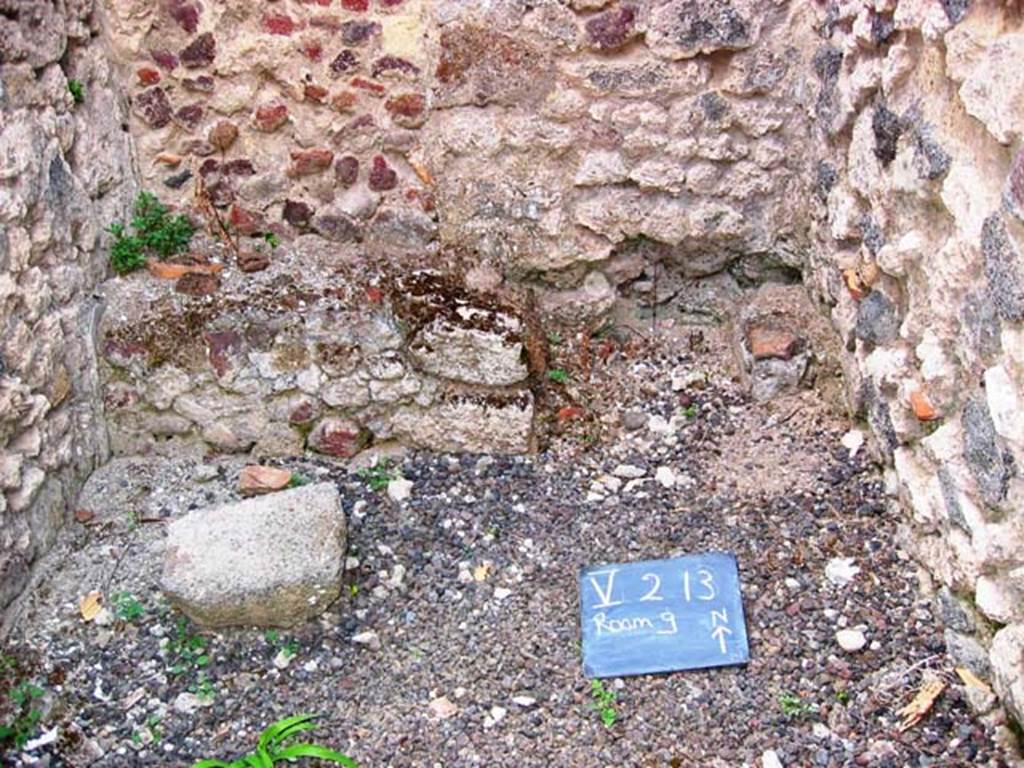 V.2.13 Pompeii. July 2008. Hearth or bench in kitchen, on left, and latrine, on right. Photo courtesy of Barry Hobson.