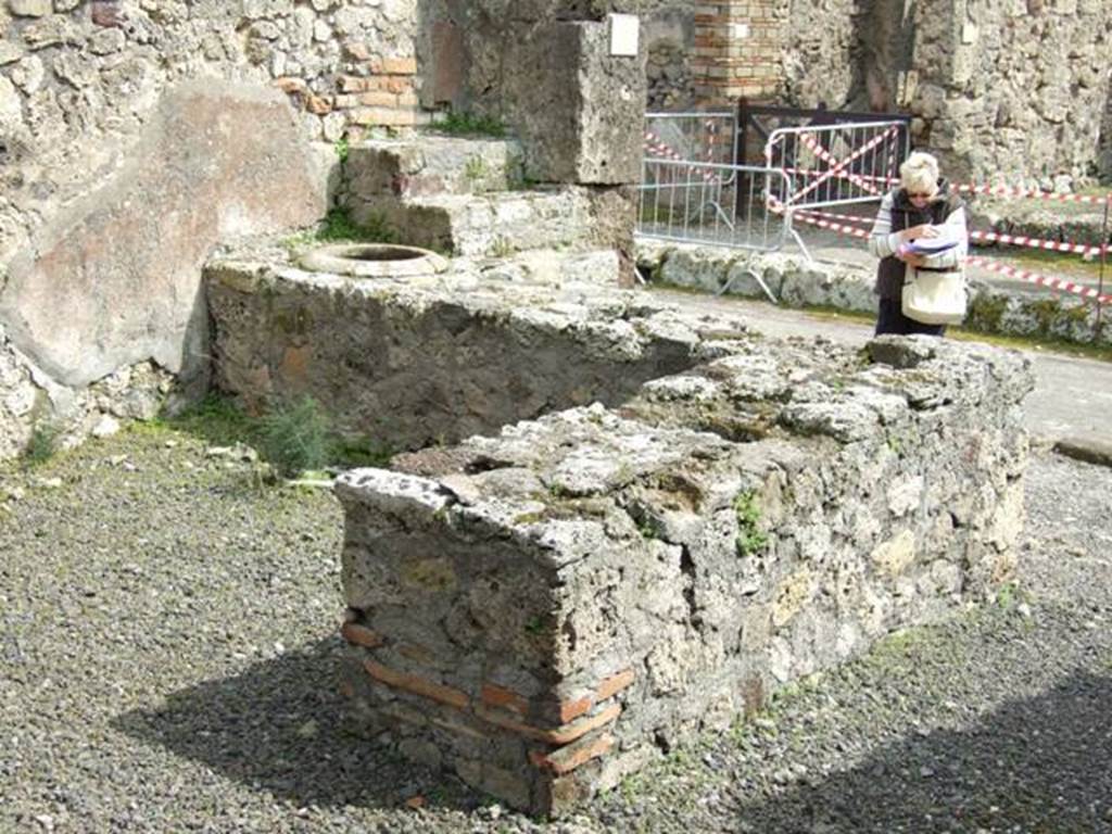 V.2.13 Pompeii,  March 2009.  Two sided counter, originally with four urns and a hearth.  Looking south east.