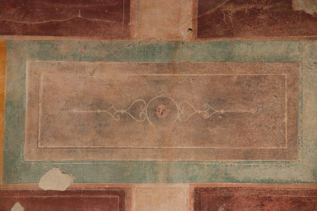 V.2.i Pompeii.  October 2023. Room 1, upper east wall above doorway to room 4, detail of painted panel. Photo courtesy of Klaus Heese.