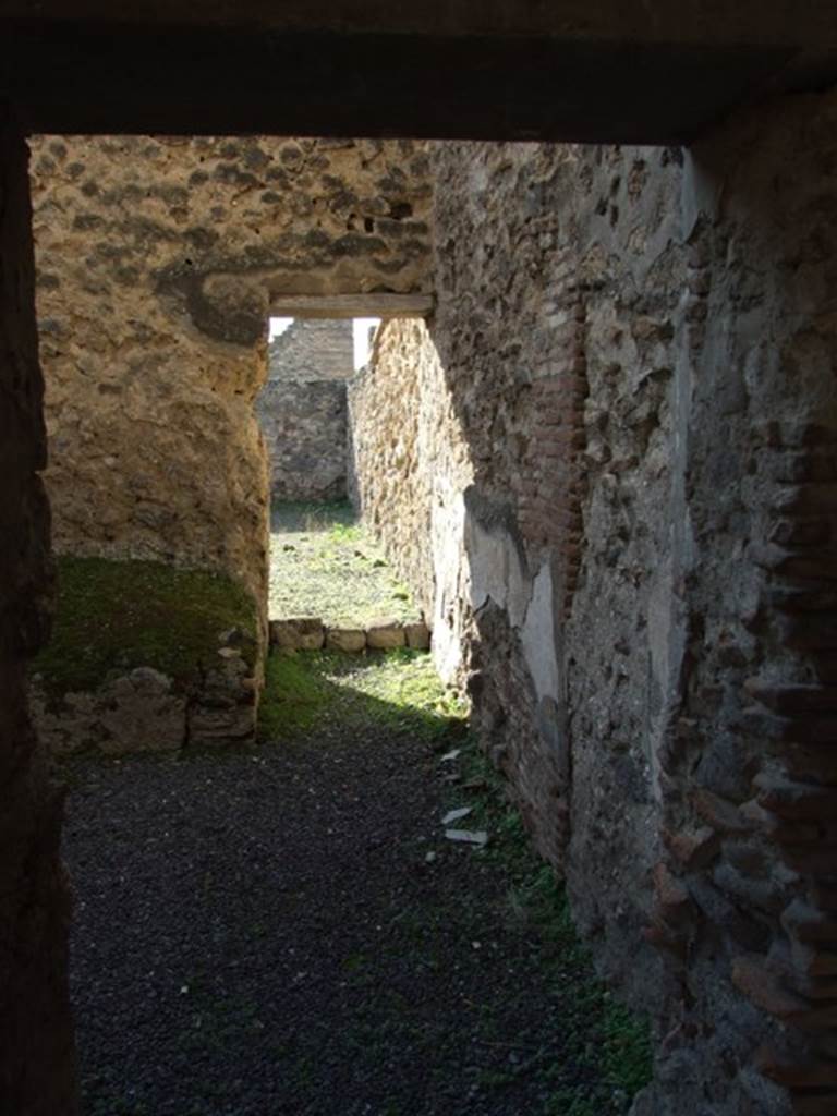 V.2.i Pompeii. December 2007. Doorway to room 11, kitchen. Looking west from peristyle through kitchen to garden area.

.