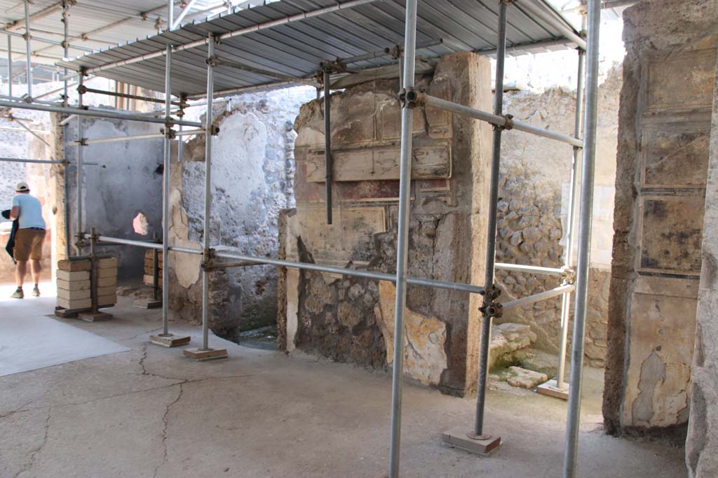 V.2.Pompeii. Casa di Orione. May 2018. Room A17 on the south side during excavation.
Photograph © Parco Archeologico di Pompei.
This room was the kitchen, a “service room” recognised by its simple decoration and the presence on the floor 
of various artefacts from table and pantry (cooking pots and tablewares) and amphorae, as well as from the finding near to the east wall of a square structure that defined a masonry hearth.  There at the time of excavation, the ash of the last baking/cooking was still preserved, covered by the upper portion of an amphora which was to serve as a lid. Presumably, the last cooked meal, and perhaps never eaten, by the owner of the house.
See Osanna M, 2019. Pompei. Il tempo ritrovato. Le Nuove Scoperte. Milano: Rizzoli, (p.99).


