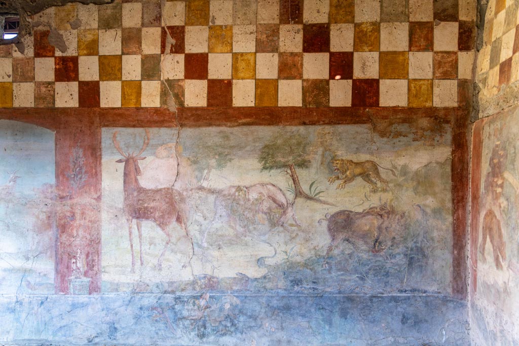 V.4.a Pompeii. October 2023. Room ‘l’ (L), hunting fresco from north wall at east end. Photo courtesy of Johannes Eber.