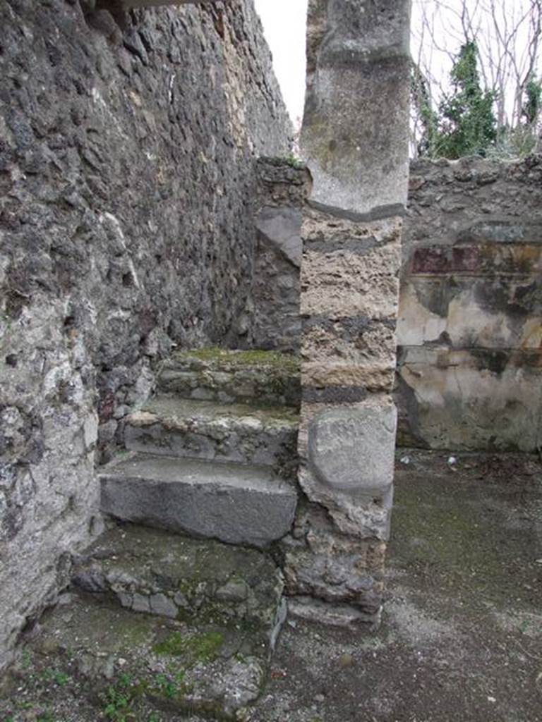 V.5.2 Pompeii. December 2007. Looking south to steps to upper floor in south-east corner of atrium. The doorway on the west side (right) of the steps led to a cubiculum “d”. The south wall, visible in the background, was decorated in the first style. These six masonry steps would have continued with wooden stairs. These steps and stairs would have been against the east wall and led above both cubiculum “d” and cubiculum “c”. See Notizie degli Scavi di Antichità, 1895, p.150
