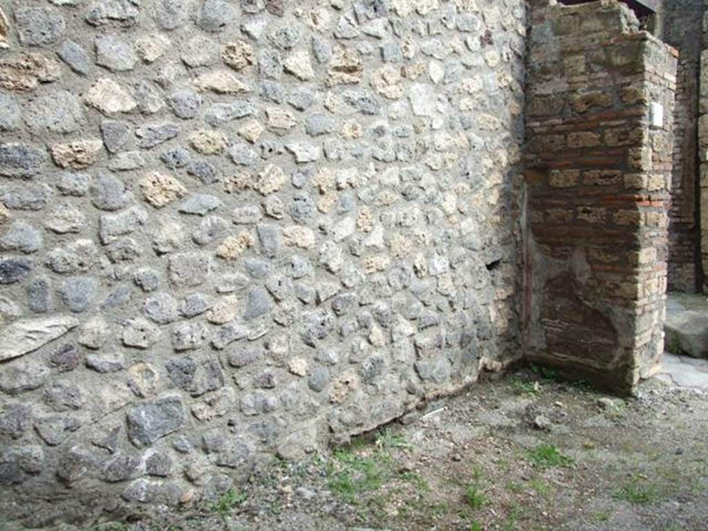 V.5.4 Pompeii. March 2009. East wall of shop. According to Boyce, in this wall there was originally a niche, referred to as a nichietta dei Penati by the excavation report. This had already been bricked-up in antiquity. Today, there is no visible sign. See Not. Scavi, 1899, 357.
See Boyce G. K., 1937. Corpus of the Lararia of Pompeii. Rome: MAAR 14. (p.42, no.131). 

