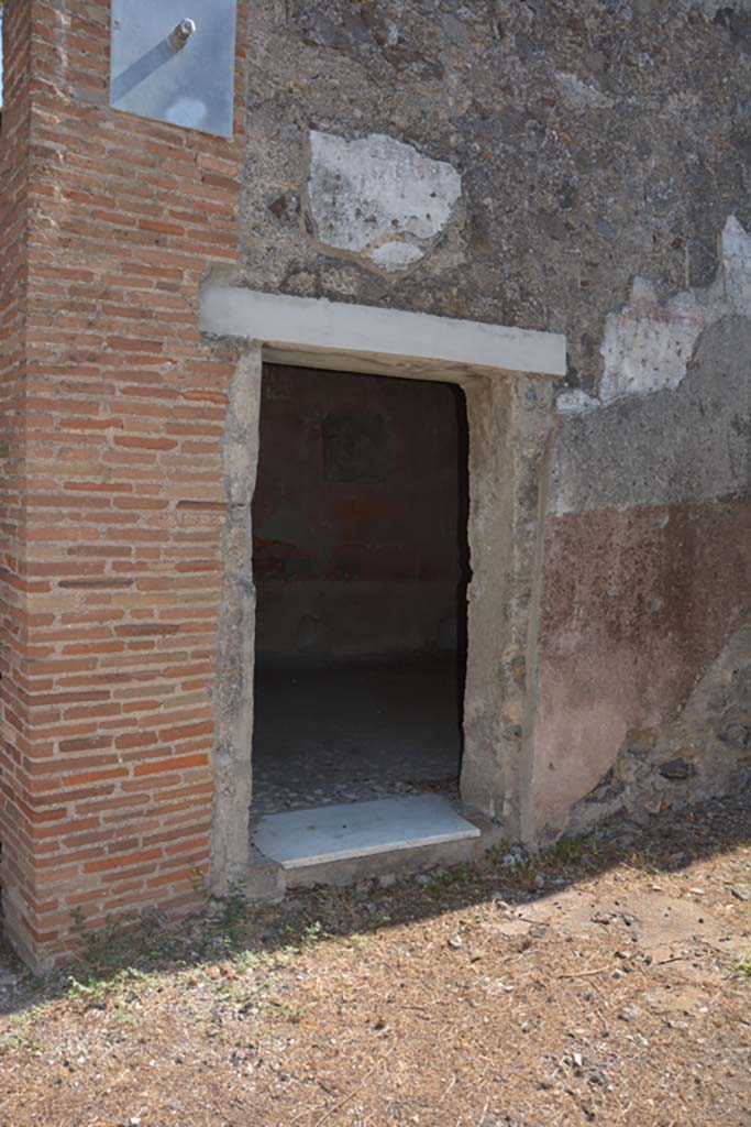 VI.1.10 Pompeii. December 2007. Doorway to room 9. Room to south of garden.  Mau identified the room at the rear, to the right of garden, with window opening onto the garden as the only room with paintings of interest:  A man sitting with a writing tablet in his hand, opposite him were 2 girls, one sitting, the other standing; the latter held a roll of papyrus, p.281, Same room, another panel, which was transferred to Naples Museum:  A young woman was represented as painting a herm of Dionysus; a cupid was holding the unfinished picture while she mixed colours on her palette. Two other maidens were watching the artist with unfeigned interest, etc , p.282, figure 133,                                       
The room contained a third picture, which is now almost obliterated.
See Mau, A., 1907, translated by Kelsey F. W. Pompeii: Its Life and Art. New York: Macmillan.  (p.280-2, T. 133).

Helbig identified:
Room to the right of the garden, God and 2 girls, 1459
Room near peristyle, Painting of Girl, 1443
Maybe in the prothyron, Bust of a Girl, 1427b
See Helbig, W., 1868. Wandgemälde der vom Vesuv verschütteten Städte Campaniens. Leipzig: Breitkopf und Härtel. (1459, 1443, 1427b).

