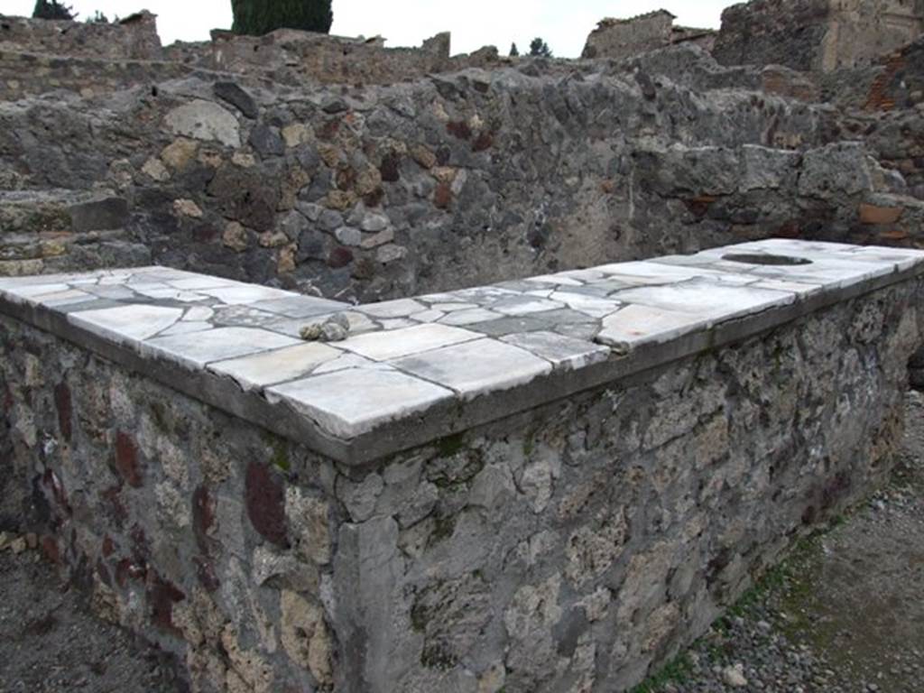 VI.1.17 Pompeii. December 2007. Two-sided marble counter with urn, hearth and two-tier shelving.