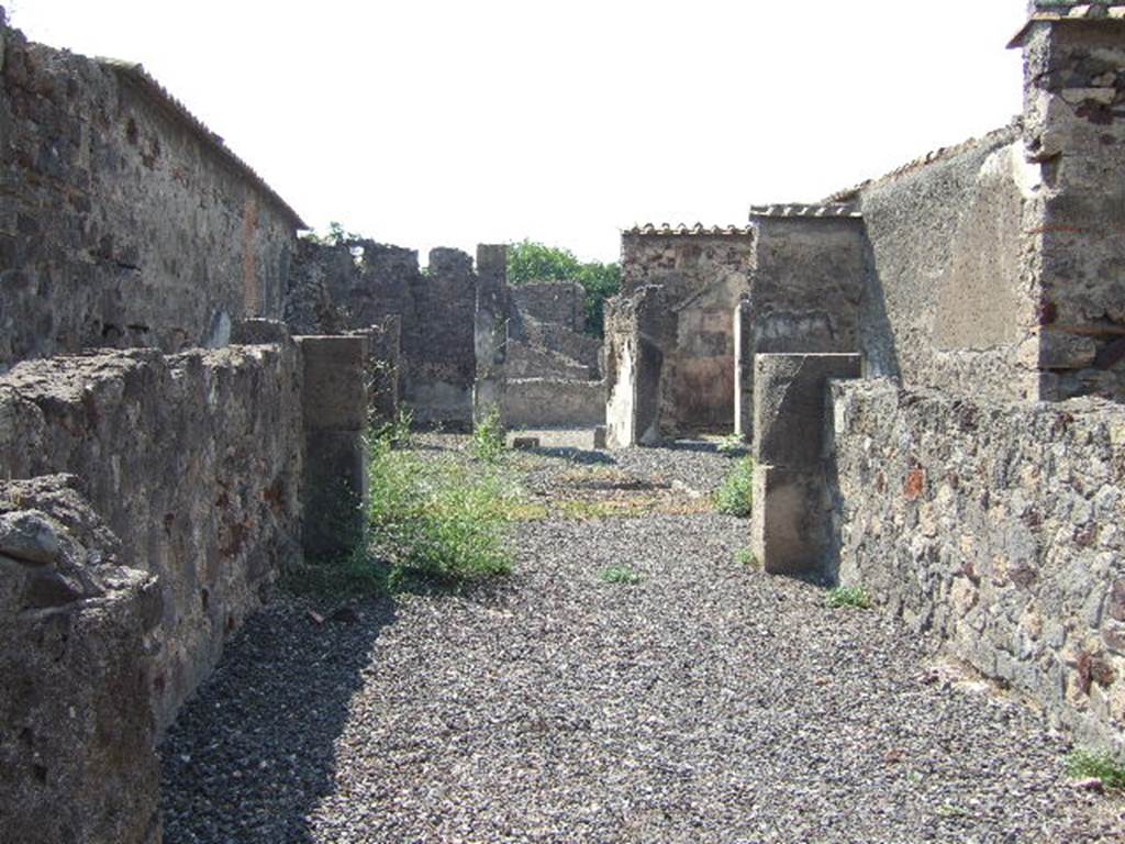 VI.2.12 Pompeii. September 2005. Looking west across tablinum 5, towards atrium 2, rooms 3 and 7 and entrance doorway.