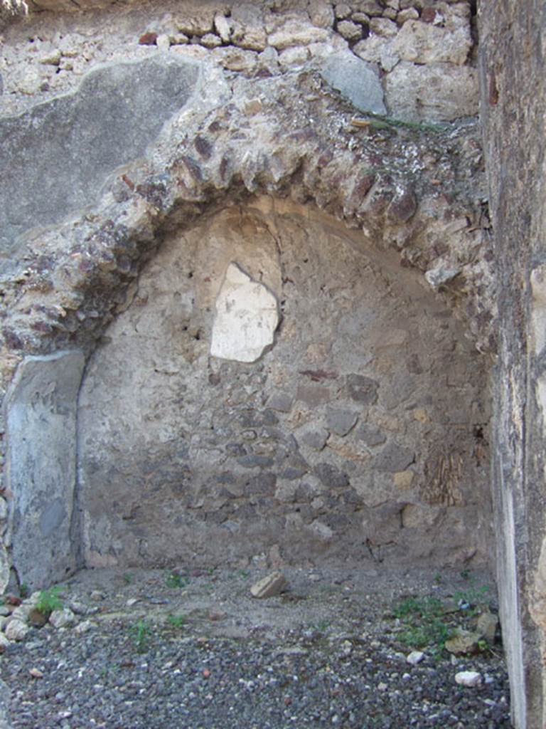 VI.2.12 Pompeii. September 2005. Room 3, room to south of fauces. South wall. Arched feature with remains of painted plaster.