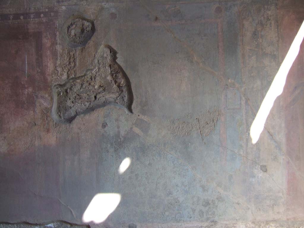 VI.2.14 Pompeii. September 2005. East wall of triclinium, remains of faded central wall painting on blue panel.