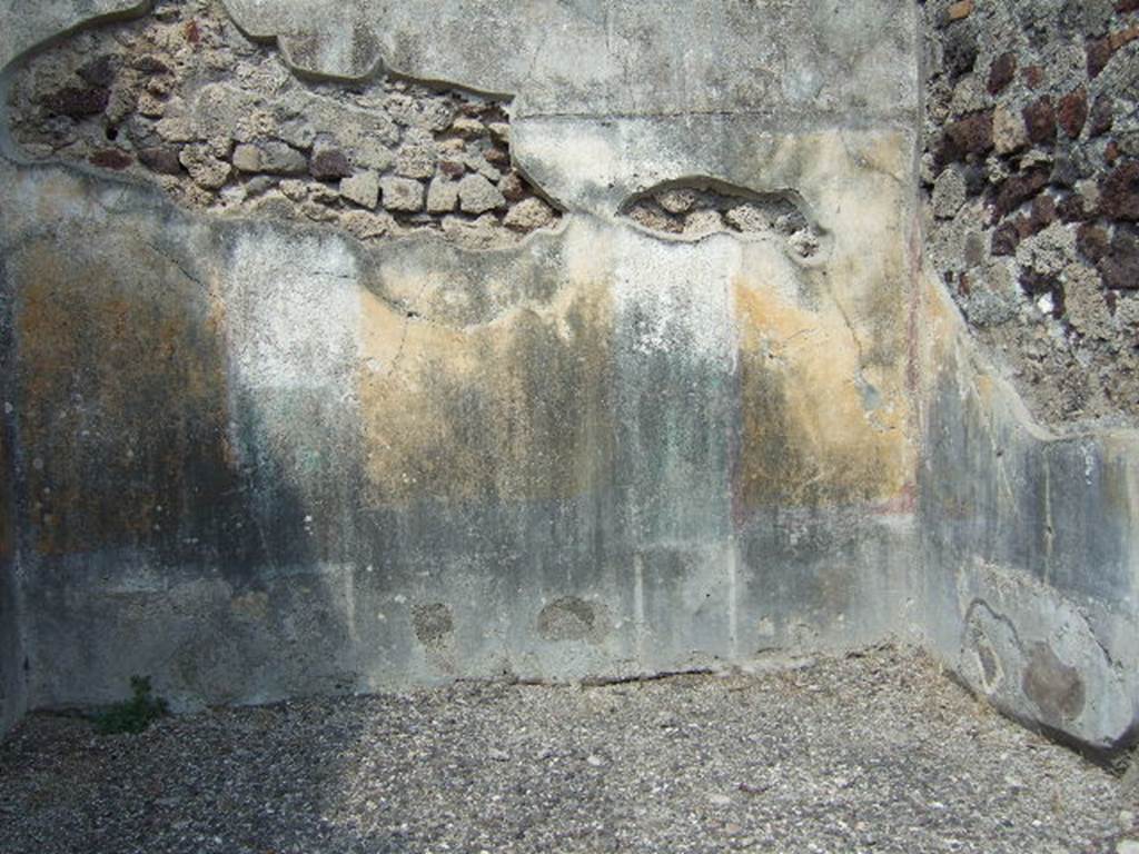 VI.2.16 Pompeii. September 2005. North wall of room on north side of peristyle. 
According to PPM –
“The north wall was preserved up until the curve of the vaulted ceiling, which was marked by a cornice of stucco, now lost. 
The wall was painted in the IV Style in a scheme with a symmetrical structure, with (yellow?) zoccolo subdivided into panels and compartments, and a yellow middle zone, with panels separated by architecture. 
Probably in this room the vignettes of Cupids, as drawn by Zahn, were to be found, (Helbig 649 and 699b). 
The upper zone of the wall was white.”
See Carratelli, G. P., 1990-2003. Pompei: Pitture e Mosaici. IV.  Roma: Istituto della enciclopedia italiana, p. 202.
See Zahn, W., 1828. Die schönsten Ornamente und merkwürdigsten Gemälde aus Pompeji, Herkulanum und Stabiae: I. Berlin: Reimer, taf. 74.
See Helbig, W., 1868. Wandgemälde der vom Vesuv verschütteten Städte Campaniens. Leipzig: Breitkopf und Härtel, (nos. 649 and 699b).
