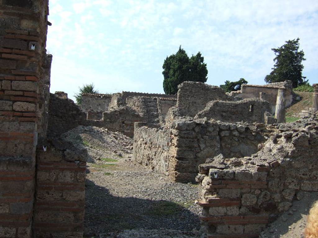 VI.2.20 Pompeii. September 2005. Looking west towards rooms on north side of open area. According to Jashemski, Fiorelli said this site, excavated 1810-11, may have been a hospitium. The entrance from the street led into an open area, which may possibly have had some plantings. A covered passageway on the right of the open area gave access to a large triclinium and two smaller rooms on the north side. See Jashemski, W. F., 1993. The Gardens of Pompeii, Volume II: Appendices. New York: Caratzas. (p.122)

