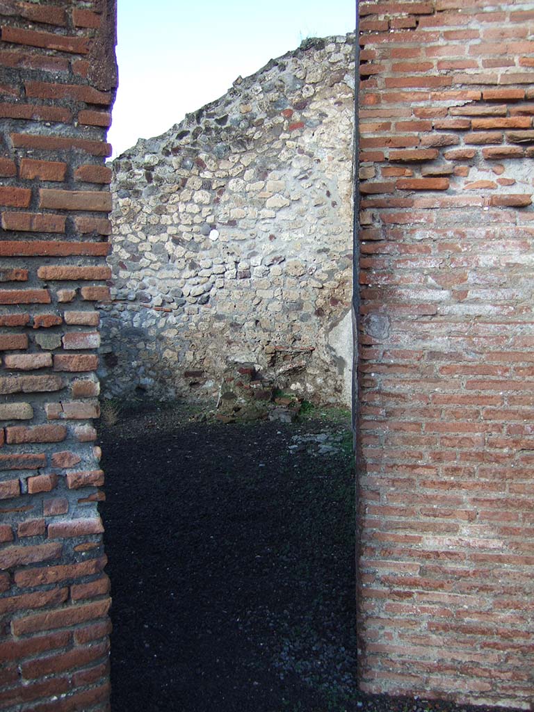 VI.3.19 Pompeii. December 2005. Looking through doorway on west side into VI.3.18.
In the centre against the north wall, can be seen the stairs to the upper floor in VI.3.18.

