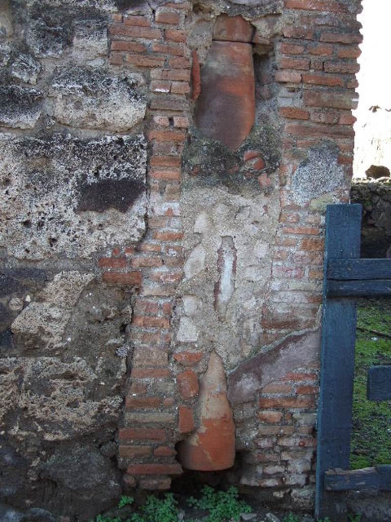 VI.3.22 Pompeii. December 2004. Downpipe from upper floor on south side of entrance.