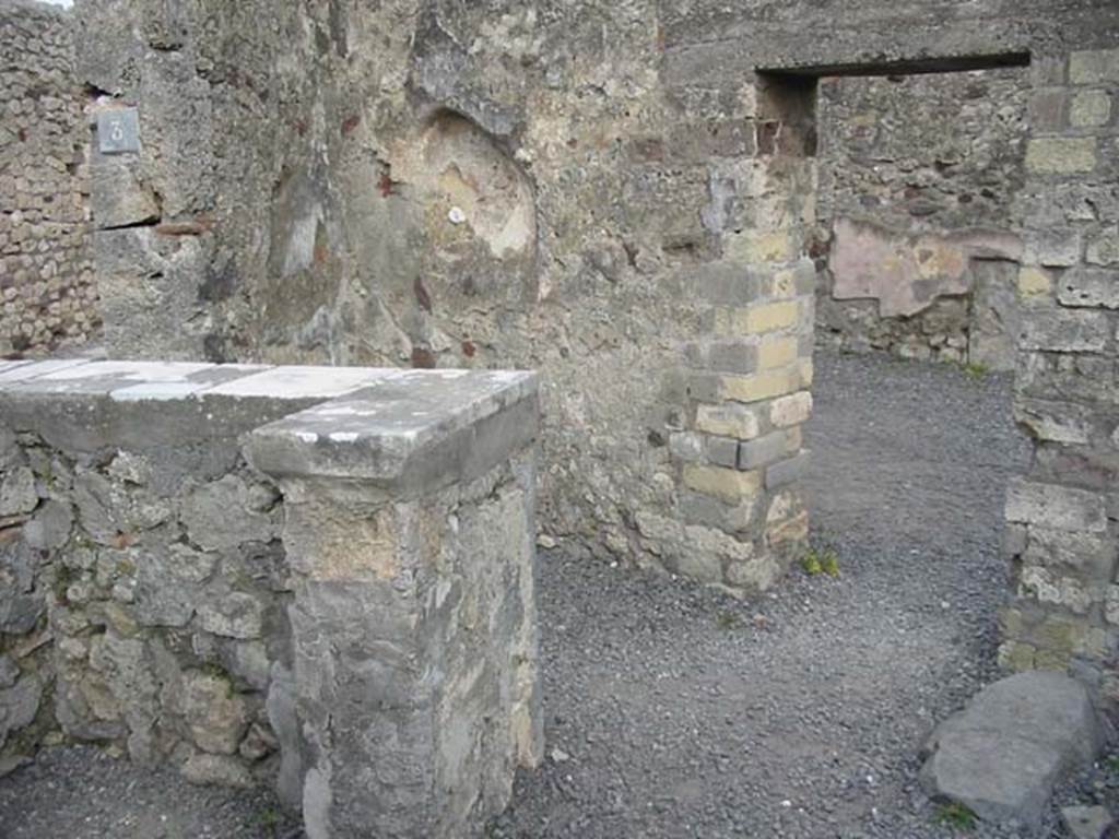 VI.4.3 Pompeii. May 2003. Looking south-east across counter towards entrance doorway, on left, and linking doorway to VI.4.4, on right. Photo courtesy of Nicolas Monteix.

