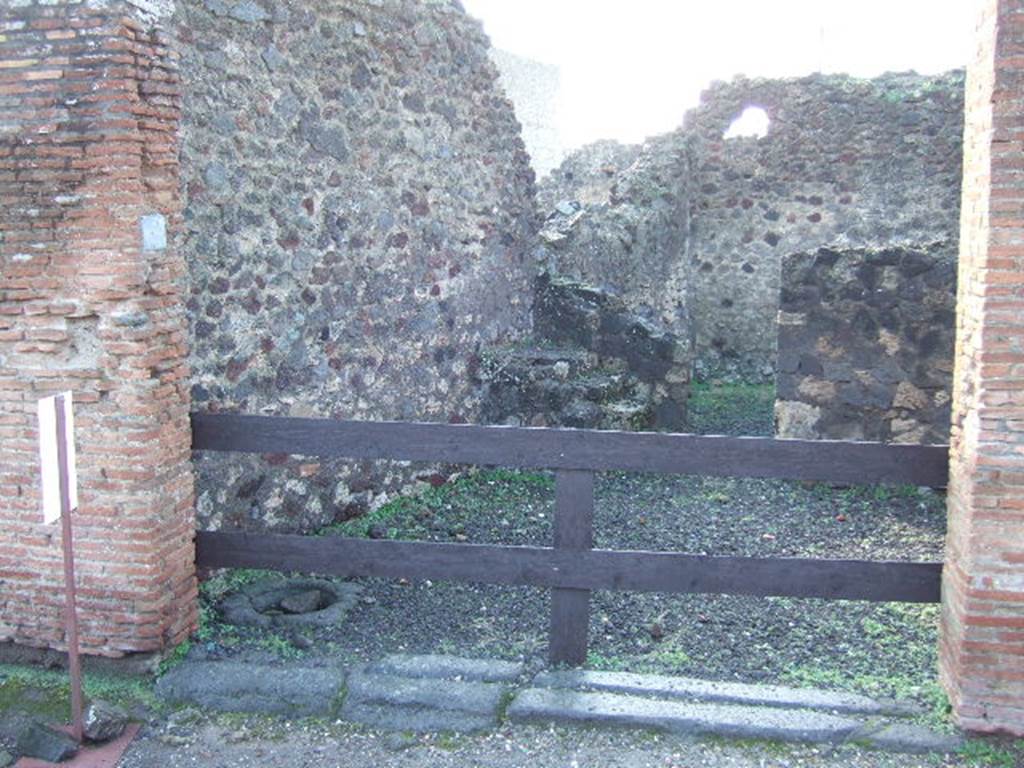 VI.4.5 Pompeii. December 2005. Looking west towards entrance doorway.
In the south-west corner of the shop can be seen steps to the upper floor, with four steps.
