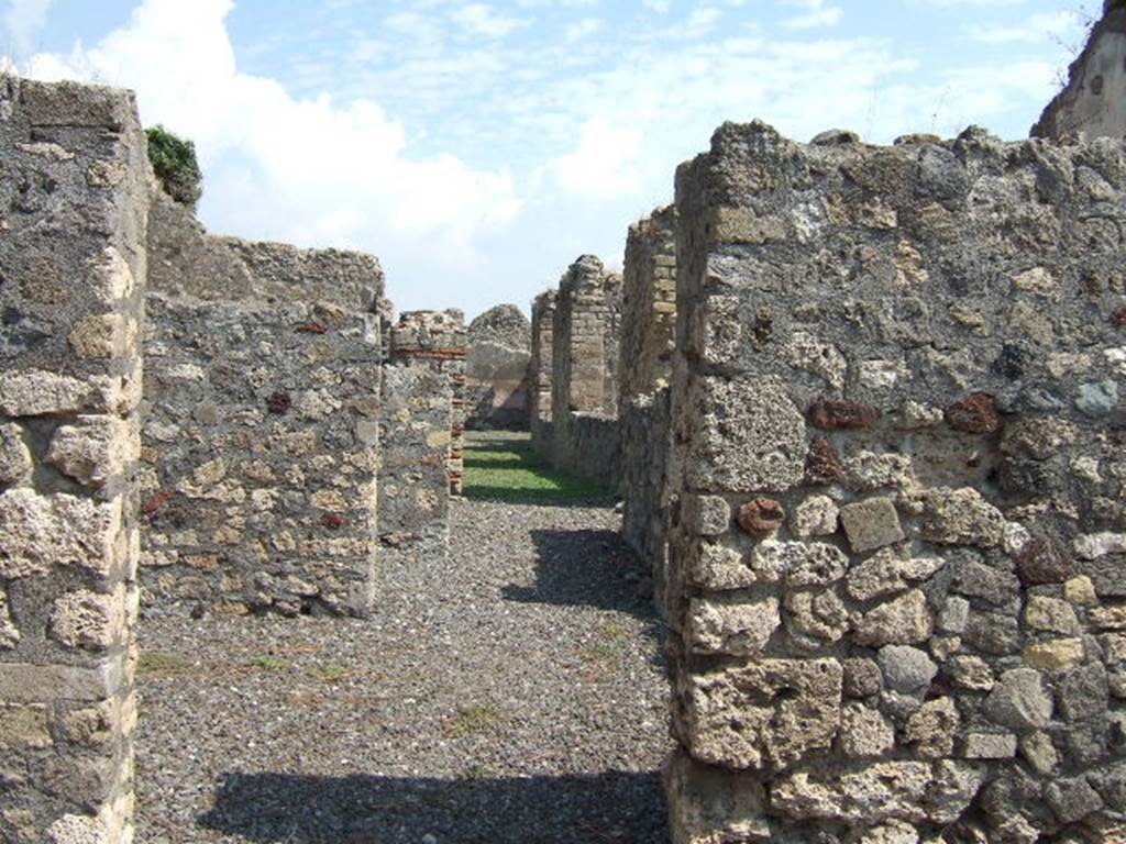 VI.5.2 Pompeii. September 2005. Looking east. According to Fiorelli, this shop had a hearth at the rear, together with a passage to the garden of the neighbouring house. It also had various rooms for the dwelling, or for the use of its industry.  What ever that was, it cannot now be known with certainty, being as this structure was entirely destroyed. See Pappalardo, U., 2001. La Descrizione di Pompei per Giuseppe Fiorelli (1875). Napoli: Massa Editore. (p.53)
