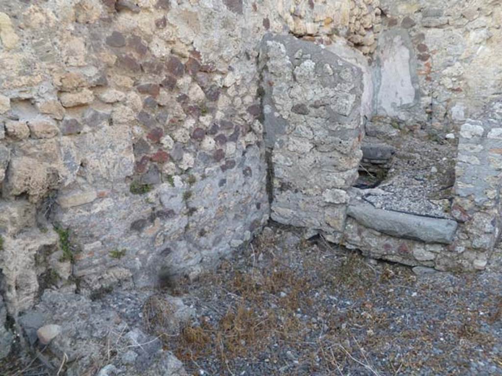 VI.5.9 Pompeii. May 2011. Doorway to latrine/small room in north-east corner of kitchen area.
According to Hobson, As a result of the lack of preservation of wood in Pompeii, no doors have been found for latrines. 
However, a large percentage of latrine rooms have threshold stones which may have grooves into which door posts were set. 
Many of the rooms have a step up from the floor of the corridor or outer room. 
This not only serves to differentiate the cubicle from other rooms, but also allows for the tile system to drain efficiently under the toilet seat.
See Hobson, B., 2009. Latrinae et foricae: Toilets in the Roman World. London; Duckworth. (p.82 and fig.105, showing grooves for doorposts).
