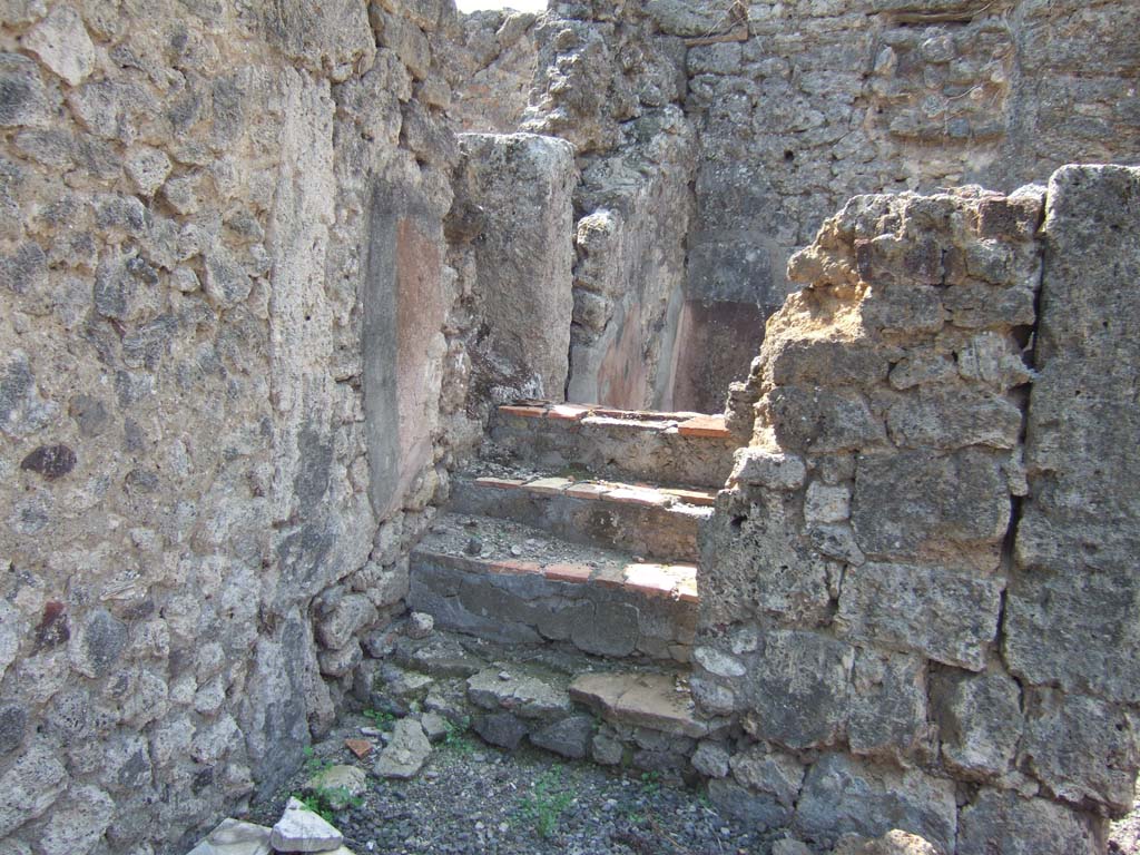VI.5.9 Pompeii. December 2007. Looking west from south-west corner of atrium, towards stairs to upper floor and doorway to cubiculum.
