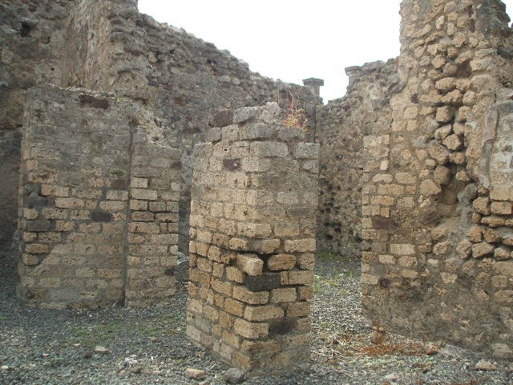 VI.6.7 Pompeii. May 2005. North-west corner of atrium with doorway to triclinium (centre). On the north side of the atrium (on right) the doorway would have led into an antechamber to both the triclinium and an oecus.
