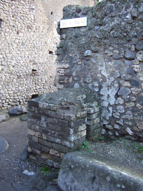 VI.6.11 Pompeii. December 2007. Base of a water column, on east side of entrance doorway.