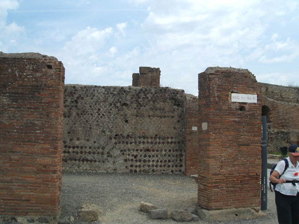 VI.6.20 Pompeii. May 2005. Looking east at entrance doorway of corner shop. According to Stefani, this was a large corner sales shop for the bakery at its rear.  On the west wall was a lararium painting with serpent, on the facing wall was a supposed “cross”. This bakery was called “the bakery of the Christians” (Panificio dei Christiani) because of the relief in stucco, now vanished. This was found on the east wall of the shop, and was wrongly interpreted as a cross, the symbol of Christianity. See Stefani, G. (2005): Pompei. Un Panificio: in Cibi e Sapori a Pompei e dintorni, (p.139) 
According to Della Corte, discovered in 1813 on the east wall in view of the road, was a panel of white stucco. On this panel in bas-relief was a Christian cross, although stylised, it was an object of veneration found opposite the pagan lararium. See Della Corte, M., 1965.  Case ed Abitanti di Pompei. Napoli: Fausto Fiorentino. (p.115)

