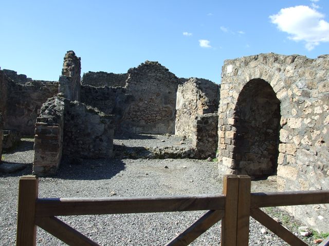 VI.7.11 Pompeii. December 2018. 
Looking south-west from entrance doorway, towards atrium of VI.7.9, showing niche in south ala, centre left. Photo courtesy of Aude Durand.
