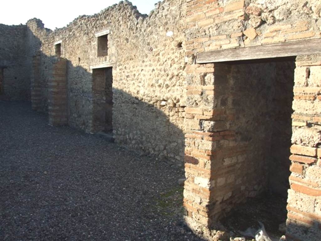 VI.7.15 Pompeii. December 2007. Looking west across yard, on the north side (right) were doorways to four small rooms.