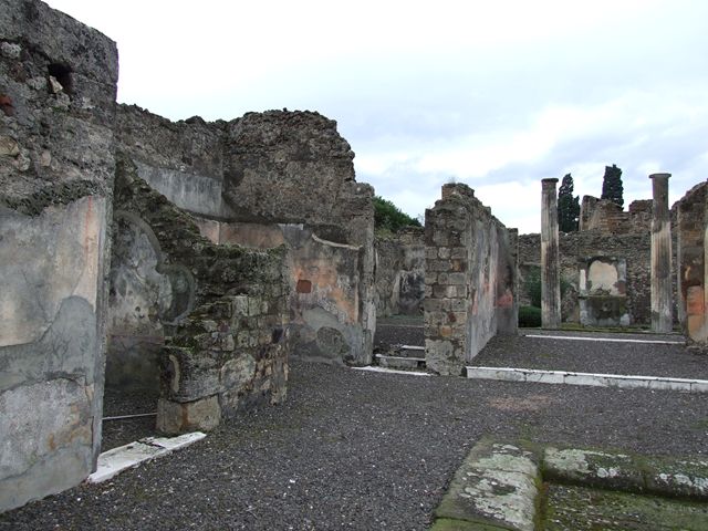VI.7.20 Pompeii. December 2006. Looking towards south-west corner of atrium, with doorways to rooms on south side, on left. In the centre is the narrow doorway to the large oecus with wide doorway overlooking the peristyle. On the right is the tablinum overlooking the peristyle.

