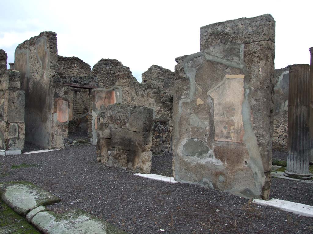 VI.7.20 Pompeii. December 2006. North-east corner of atrium, with doorway to room on north side of entrance corridor, on right.
