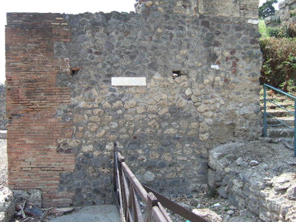 231624 Bestand-D-DAI-ROM-W.1268.jpg
VI.7.26 Pompeii. W.1268. Wall façade on north side of entrance, with remains of wall blocking the street, which had a street shrine in its centre.
Photo by Tatiana Warscher. With kind permission of DAI Rome, whose copyright it remains. 
See http://arachne.uni-koeln.de/item/marbilderbestand/231624 
