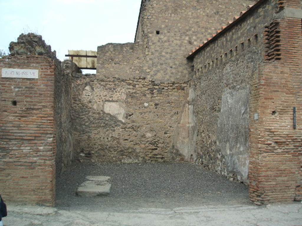 VI.8.4 Pompeii. May 2005. Looking north to shop entrance doorway.
According to Pagano and Prisciandaro, various graffiti were found written on the south-west corner of insula 8.  They may have been written on the pilaster (on the left) or may have been around the corner, on the side wall. 
Written in red – C(aium) Iulium Polybium IIvir(um)    [CIL IV 147 = CIL IV 258]
M(arcum) Cerrinium    [CIL IV 256]
Suettium    [CIL IV 257]
Nero L() <Po=OP>pae(a)e ses factum    [CIL IV 259]
M(arcum) Mallium aed(ilem)    [CIL IV 260]
See Pagano, M. and Prisciandaro, R., 2006. Studio sulle provenienze degli oggetti rinvenuti negli scavi borbonici del regno di Napoli. Naples : Nicola Longobardi.  (p.129) 

