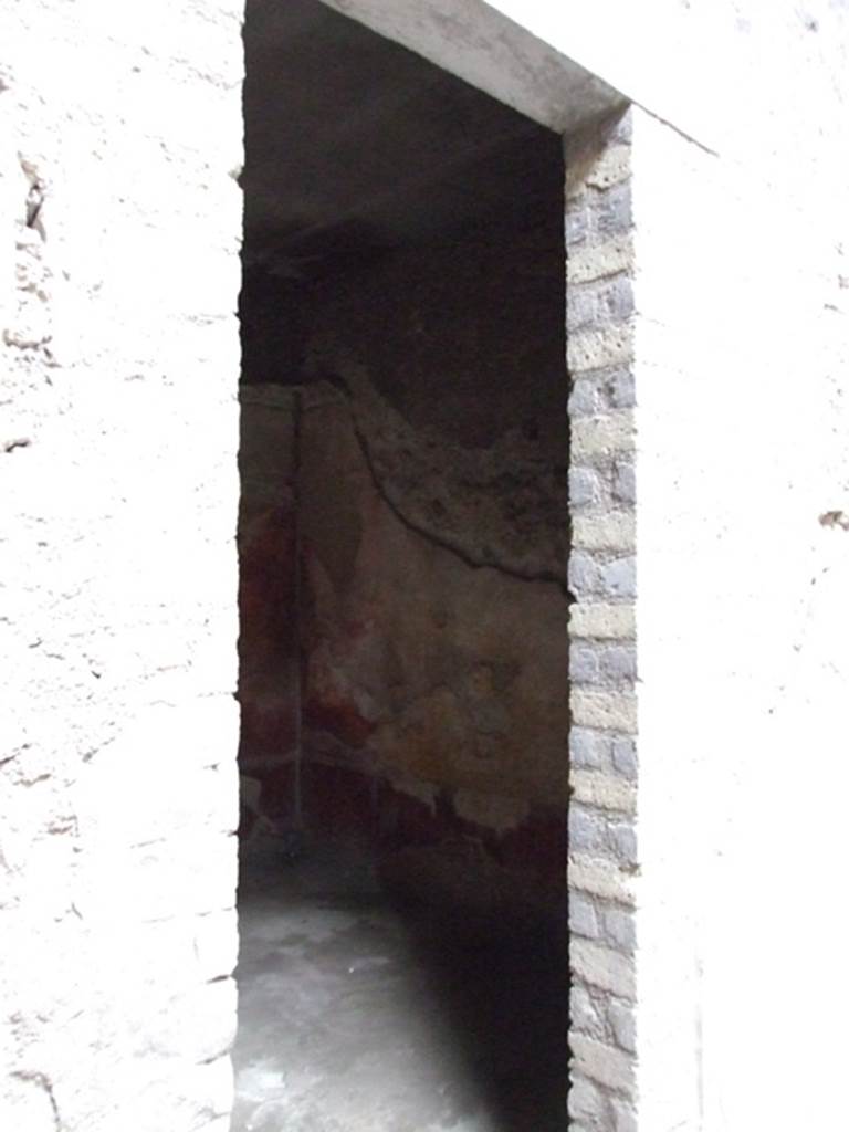 VI.8.5 Pompeii. March 2009. Doorway to room 9, cubiculum. 
According to Bianco in Rivista di Studi Pompeiani, when found this cubiculum was beautifully decorated.
Today the decoration has been totally lost.
The lower walls would have had a dark red dado (zoccolo).
The walls were divided into red and yellow panels, the middle panel on each wall was yellow.
In the central yellow panel were mythological paintings.
Apollo and Daphne on the north wall.
Europa on the Bull on the south wall.
Phryxus and Helle on the west wall.
On the east wall was the doorway to the atrium.
On high was a frieze showing Amazons, this was interrupted in the centre of the west wall with a painting of Venus Pompeiana.
See Bianco, A. Il fregio delle Amazzoni nella Casa del Poeta Tragico a Pompei: Rivista di Studi, XVIII, 2007, Roma: L’erma di Bretschneider, p.54-66 with photos.
See Bragantini, de Vos, Badoni, 1983. Pitture e Pavimenti di Pompei, Parte 2. Rome: ICCD. (p.173, room numbered as cubiculum 6a).
