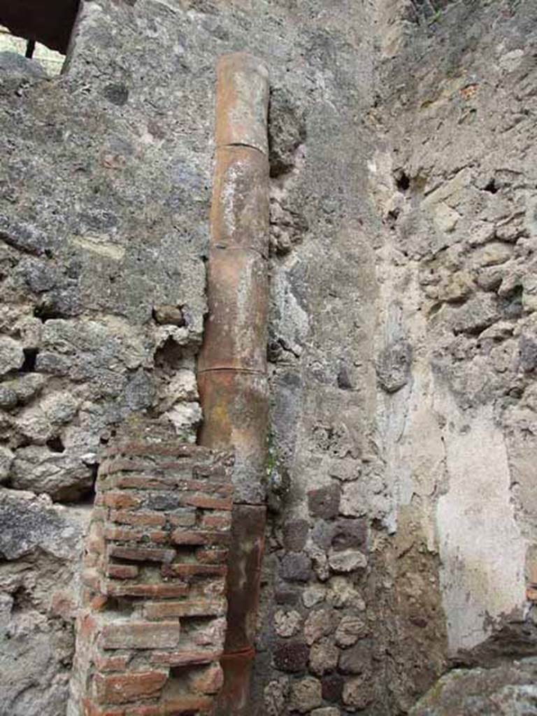 VI.8.8 Pompeii. May 2010. Downpipe in south-west corner of latrine.