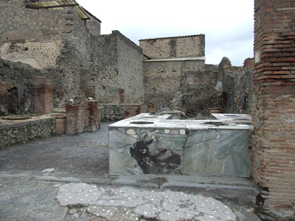 VI.8.8 Pompeii. March 2009. Entrance with three sided marble counter with six urns and a hearth.