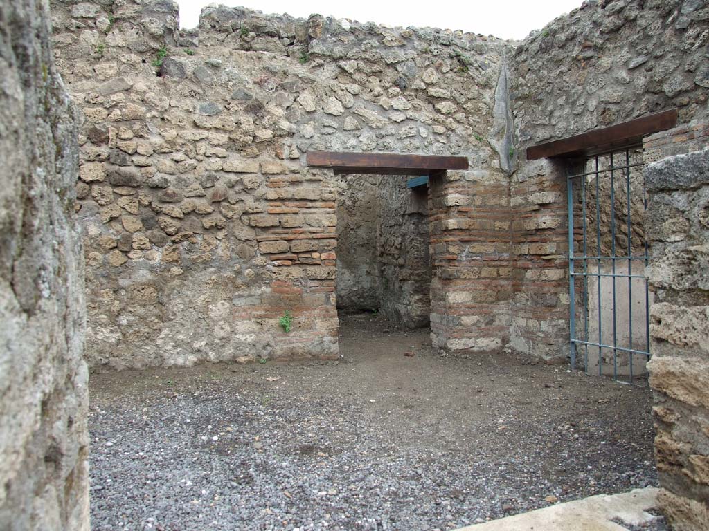 VI.8.9 Pompeii. May 2010. 
Looking north into rear room, reached by two steps. The doorway, with blue gates, would have linked to VI.8.13.
