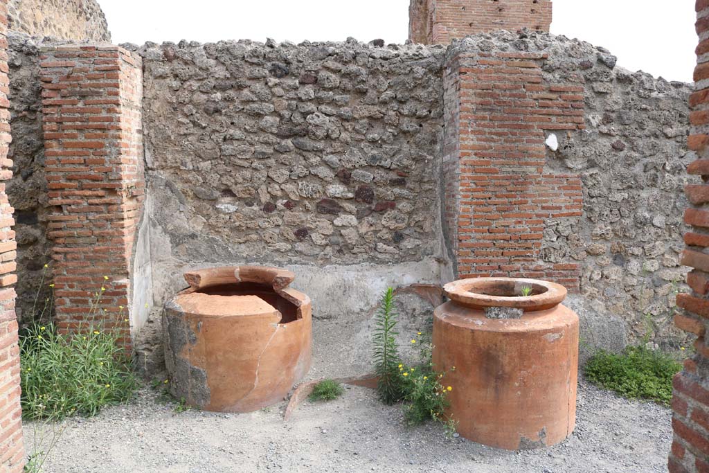 VI.8.9 Pompeii. December 2018. 
Remains of four dolia against the east wall in the north-east corner of the thermopolium. Photo courtesy of Aude Durand.
