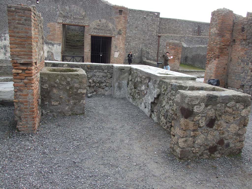 VI.8.9 Pompeii. December 2007.  North-east corner of large rear room, with open doorway to small room at rear.  The barred gate is the doorway to VI.8.13.
