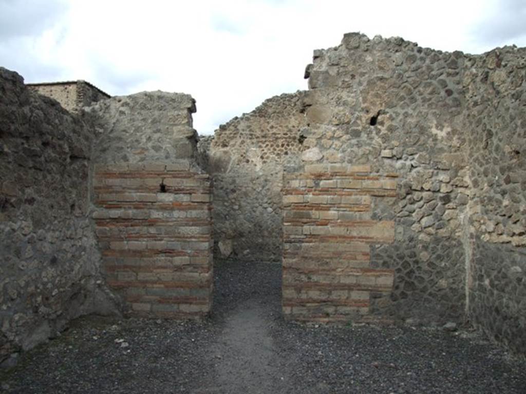 VI.8.11 Pompeii.  Shop.  December 2007.  North wall with door to rear room.